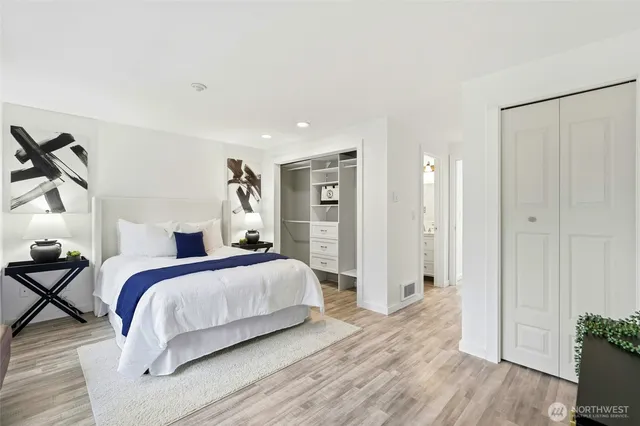 a bedroom with a bed and a potted plant