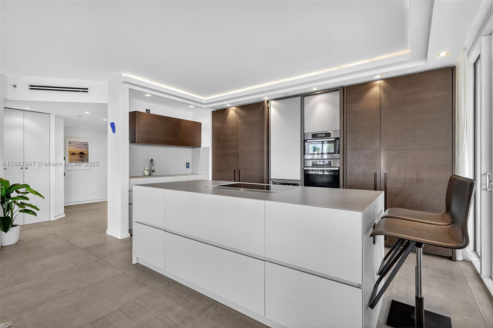 3000 Island Boulevard, Unit 906 Aventura, FL 33160 - Photo 11 of 58 a living room with furniture and a flat screen tv