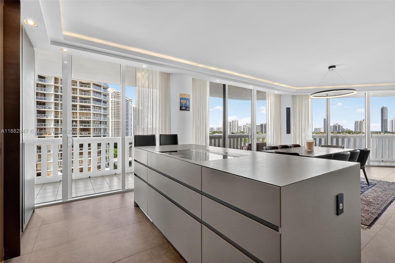 3000 Island Boulevard, Unit 906 Aventura, FL 33160 - Photo 12 of 58 a large white kitchen with granite countertop a sink and a large window
