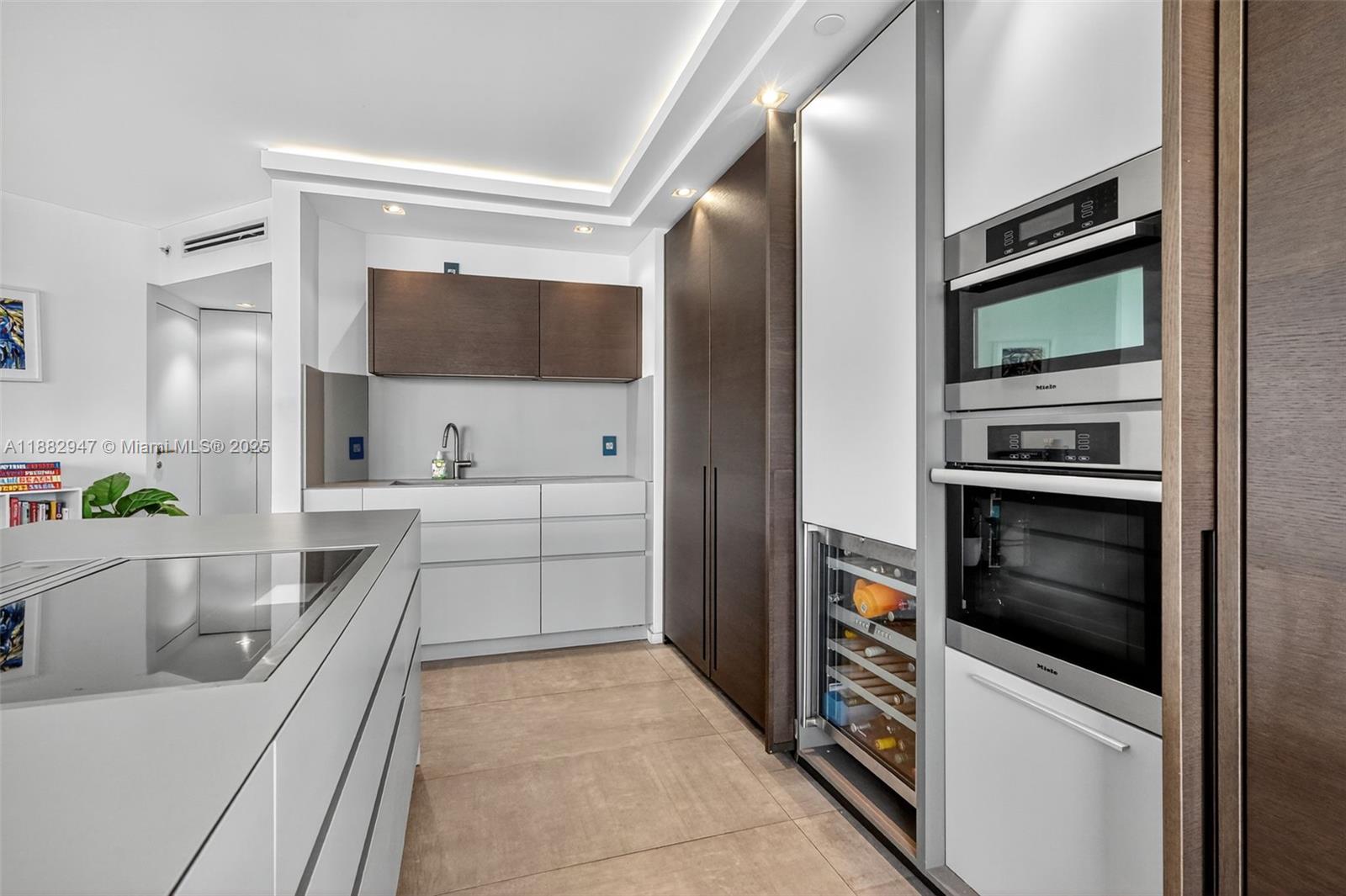 3000 Island Boulevard, Unit 906 Aventura, FL 33160 - Photo 15 of 58 a kitchen with a refrigerator stove and sink