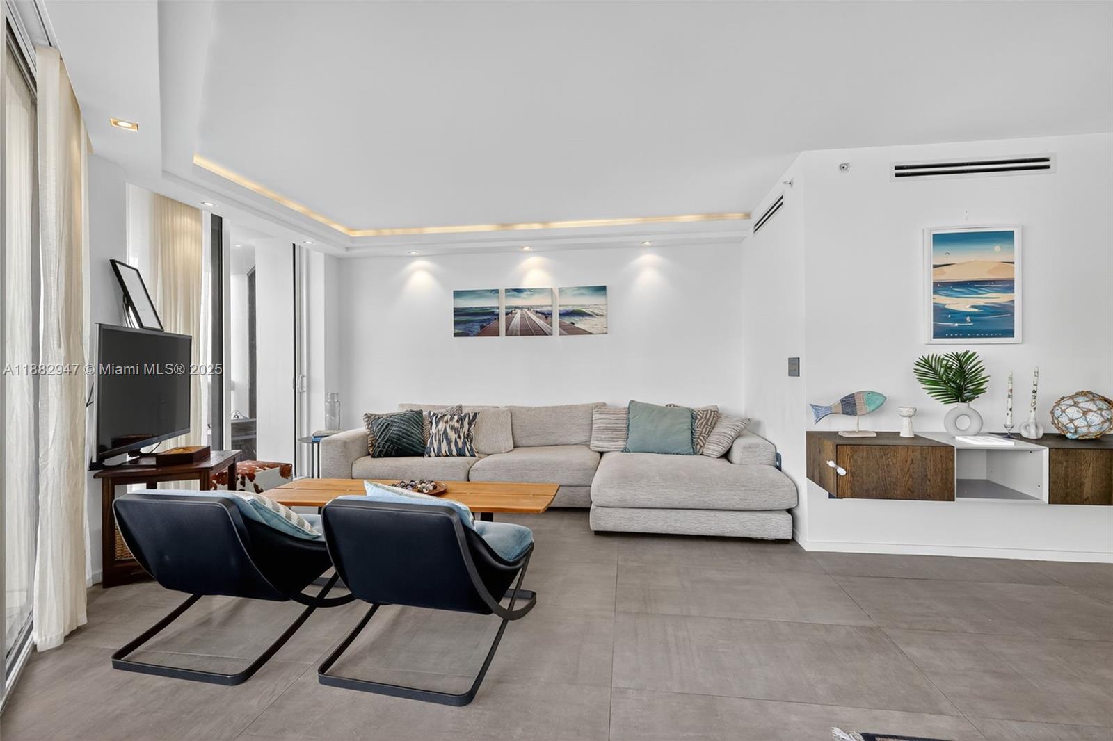 3000 Island Boulevard, Unit 906 Aventura, FL 33160 - Photo 17 of 58 a living room with furniture and a flat screen tv