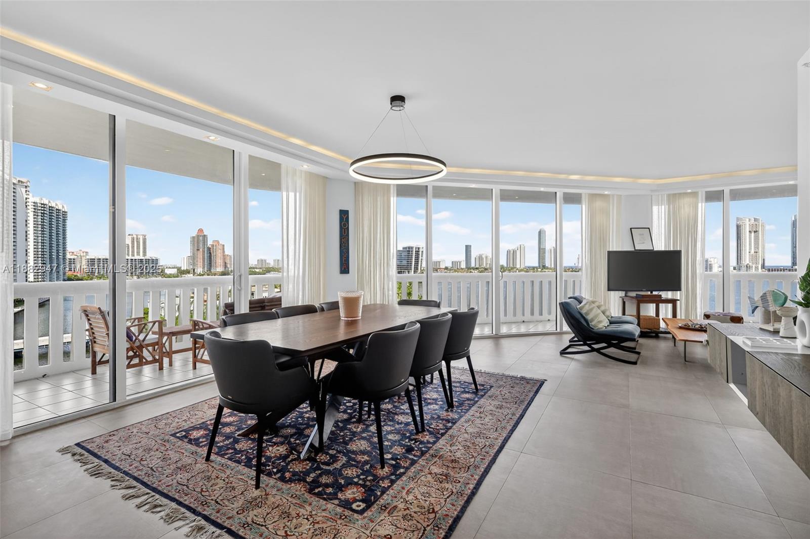 3000 Island Boulevard, Unit 906 Aventura, FL 33160 - Photo 2 of 58 a view of a dining room with furniture window and wooden floor