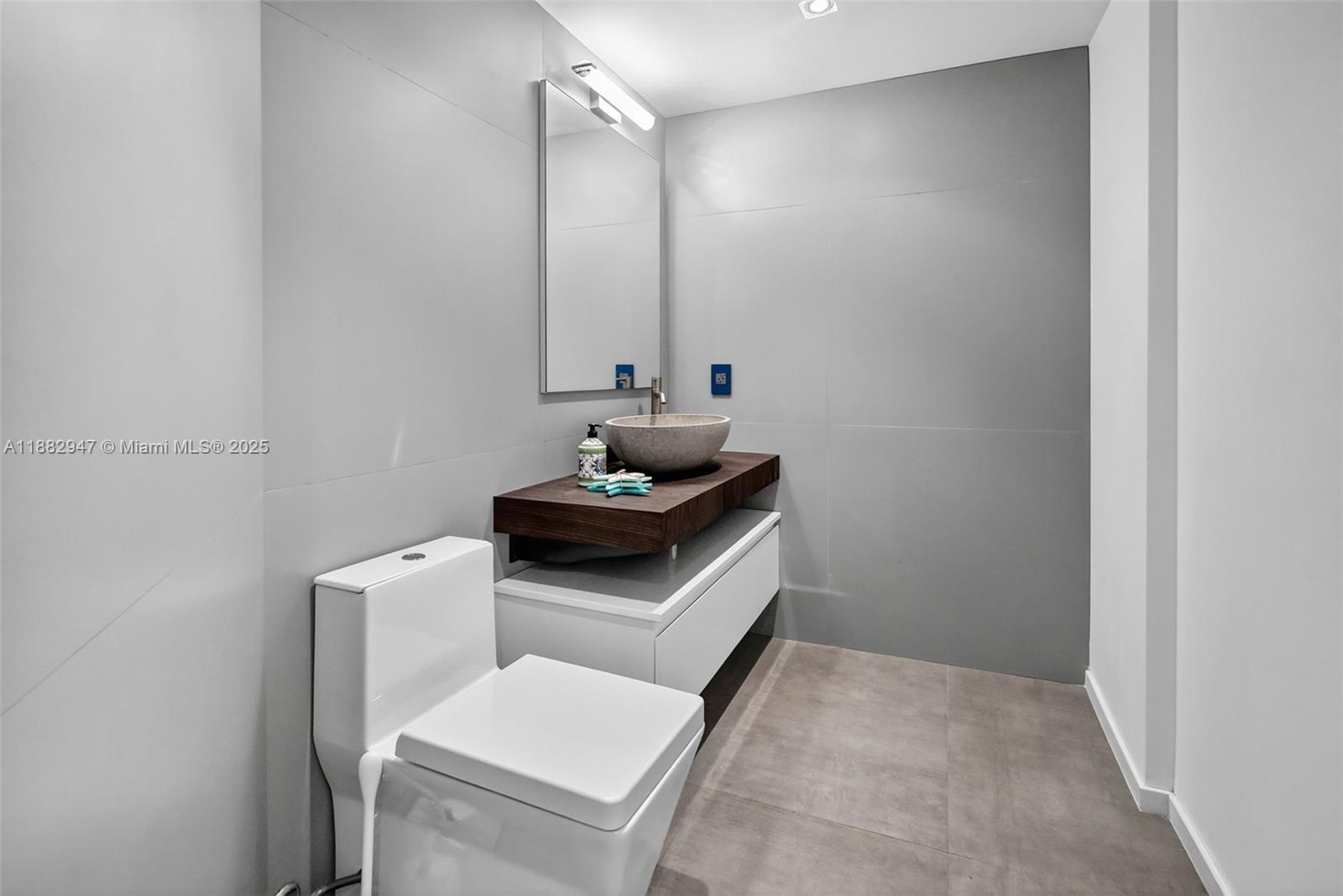 3000 Island Boulevard, Unit 906 Aventura, FL 33160 - Photo 21 of 58 a bathroom with a sink and a toilet