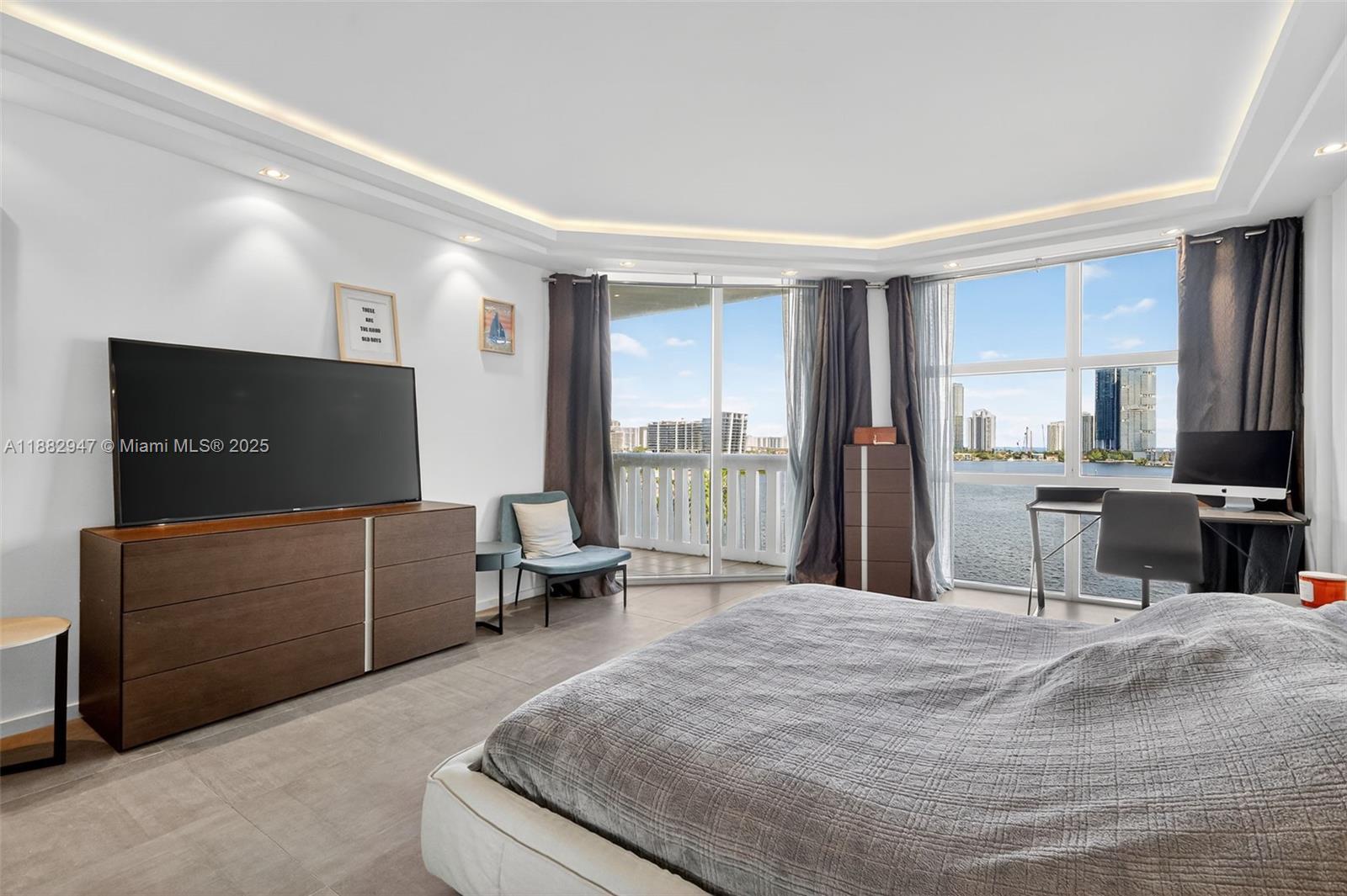 3000 Island Boulevard, Unit 906 Aventura, FL 33160 - Photo 24 of 58 a living room with furniture and a flat screen tv