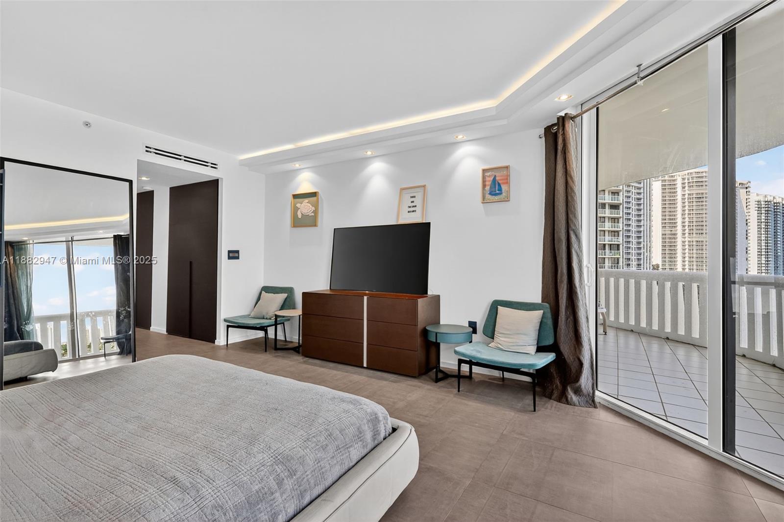 3000 Island Boulevard, Unit 906 Aventura, FL 33160 - Photo 26 of 58 a bedroom with a bed and a television