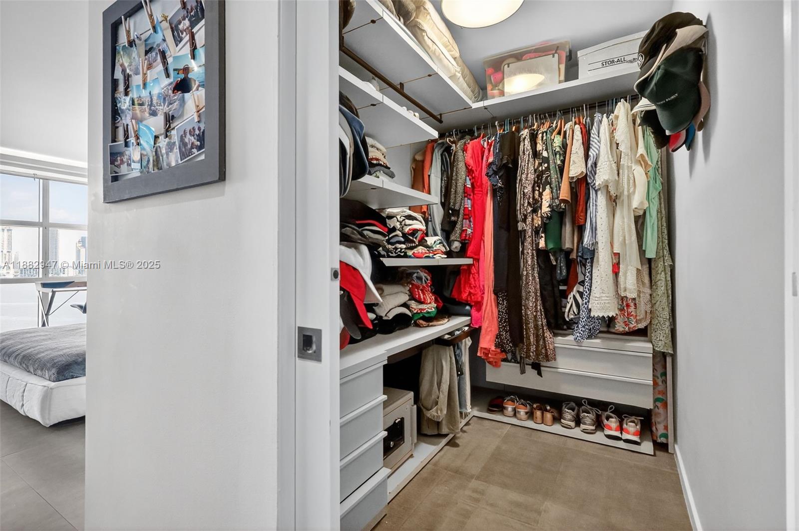 3000 Island Boulevard, Unit 906 Aventura, FL 33160 - Photo 27 of 58 a view of walk in closet with clothes and shoes
