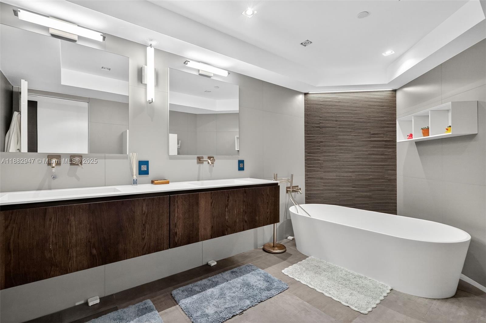 3000 Island Boulevard, Unit 906 Aventura, FL 33160 - Photo 29 of 58 a spacious bathroom with a double vanity sink a mirror and a bathtub