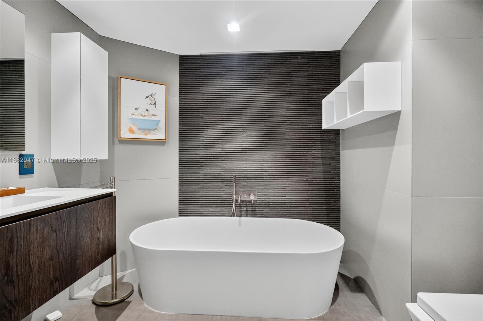 3000 Island Boulevard, Unit 906 Aventura, FL 33160 - Photo 36 of 58 a white bath tub sitting in a bathroom