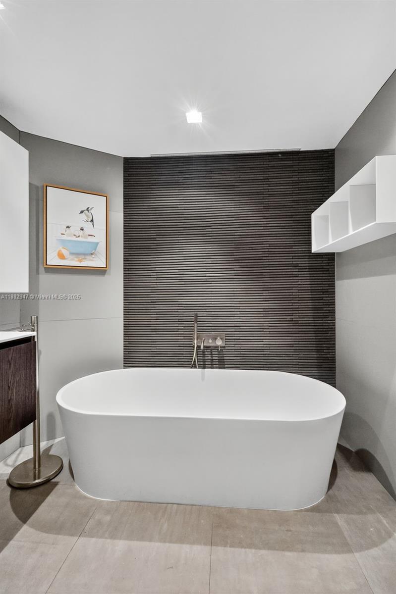 3000 Island Boulevard, Unit 906 Aventura, FL 33160 - Photo 37 of 58 a white tub sitting in a bathroom