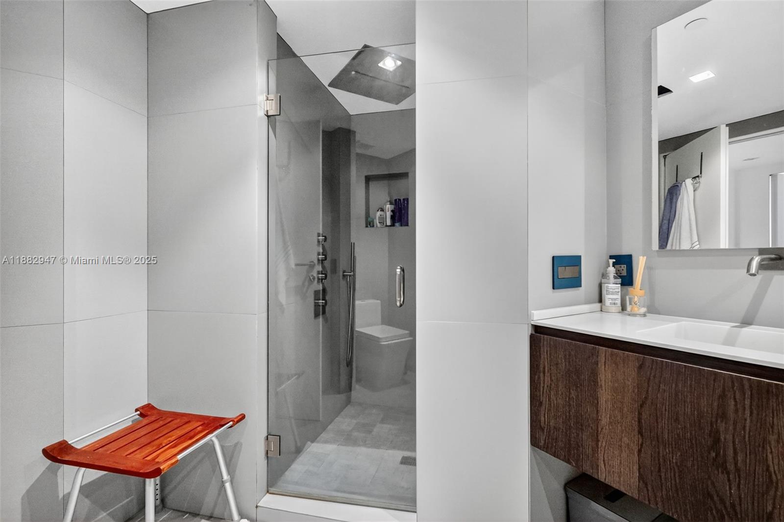 3000 Island Boulevard, Unit 906 Aventura, FL 33160 - Photo 38 of 58 a bathroom with a sink a toilet and a mirror