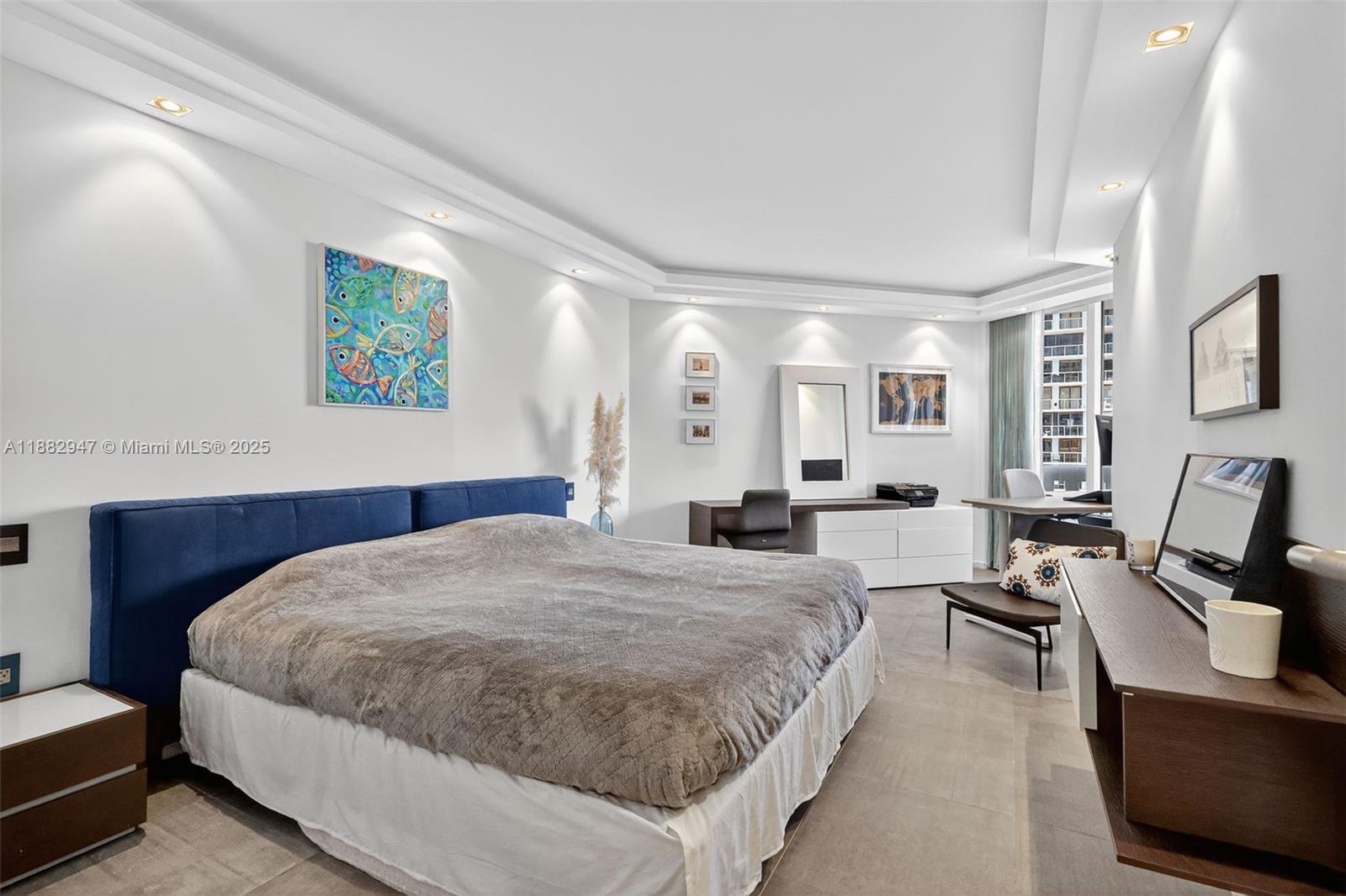 3000 Island Boulevard, Unit 906 Aventura, FL 33160 - Photo 41 of 58 a spacious bedroom with a bed a couch and a window