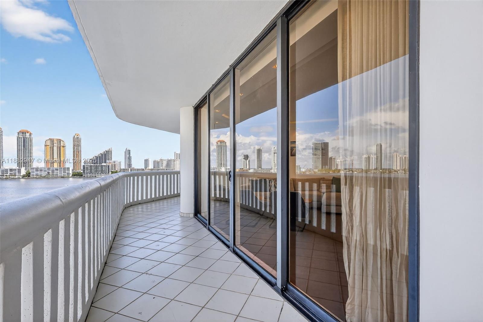 3000 Island Boulevard, Unit 906 Aventura, FL 33160 - Photo 50 of 58 a view of a balcony with furniture