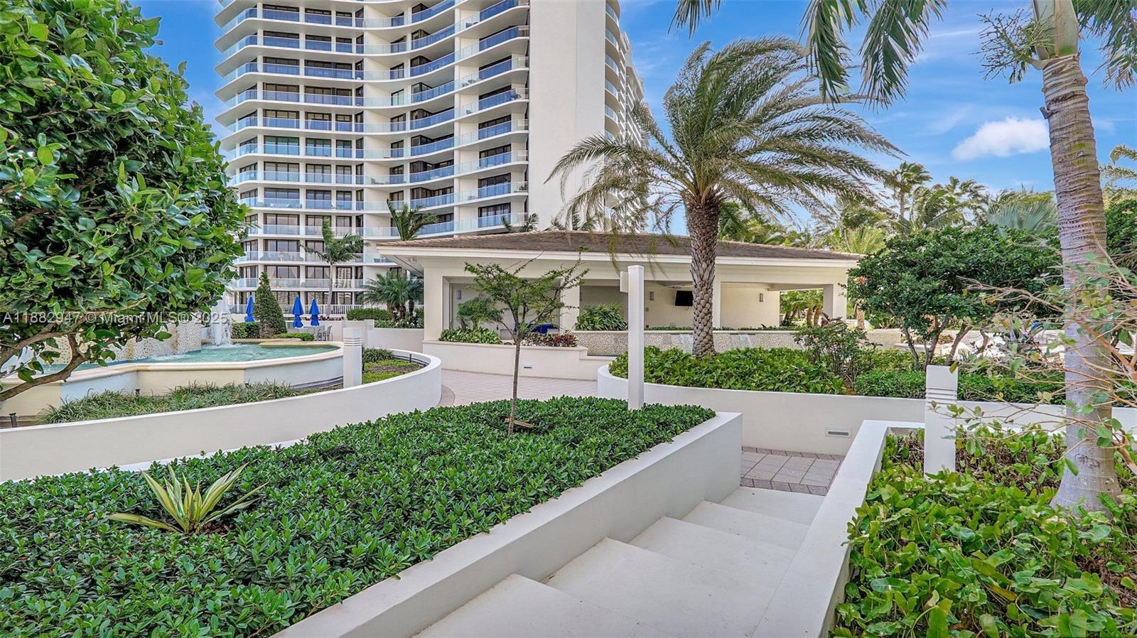 3000 Island Boulevard, Unit 906 Aventura, FL 33160 - Photo 55 of 58 a view of a garden with a fountain