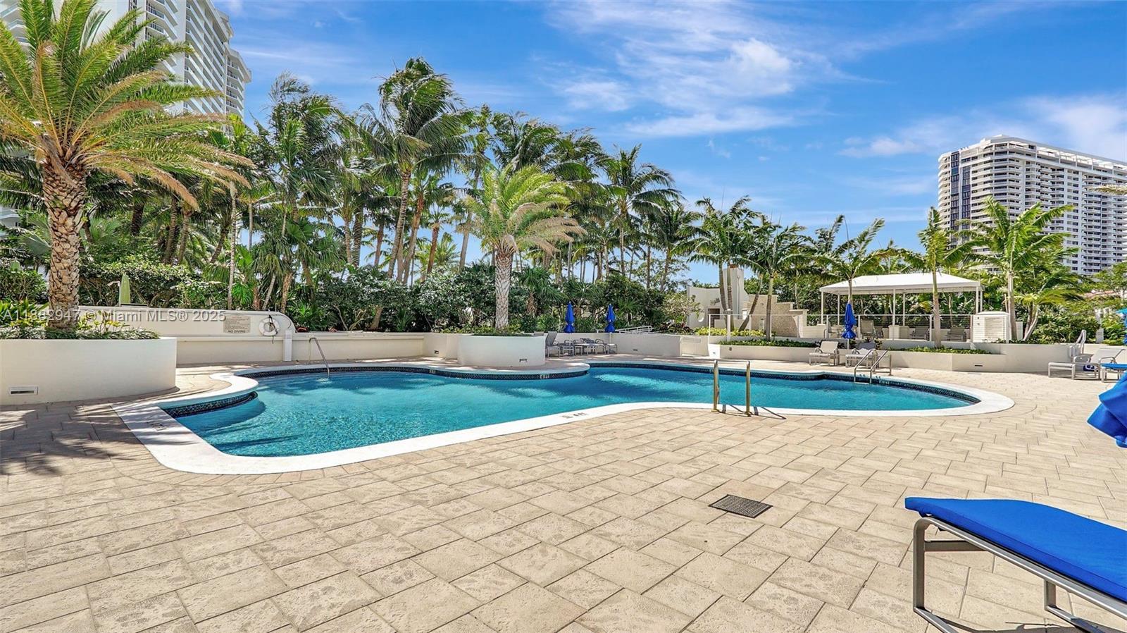 3000 Island Boulevard, Unit 906 Aventura, FL 33160 - Photo 58 of 58 a view of a swimming pool with a yard