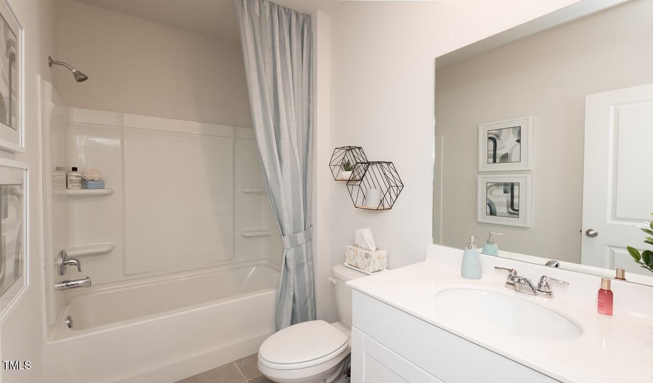 600 Red River Drive Garner, NC 27529 - Photo 10 of 16 a bathroom with a sink a toilet and a bathtub