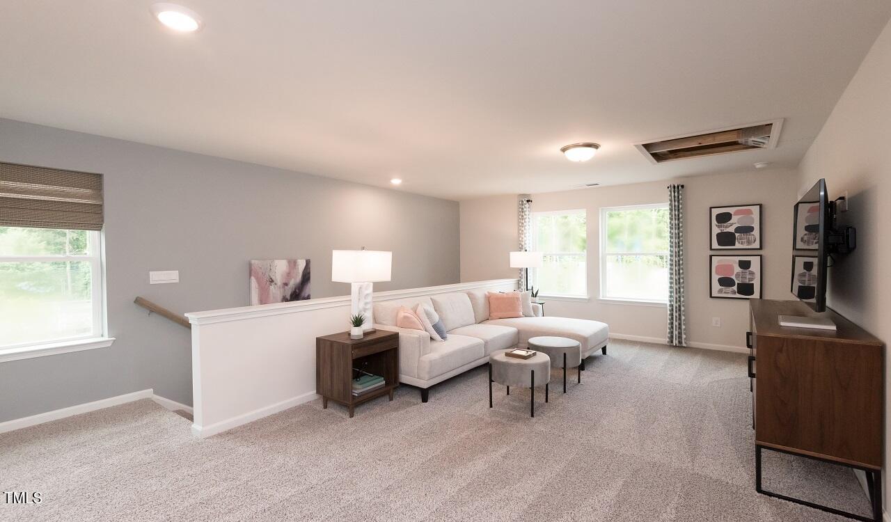600 Red River Drive Garner, NC 27529 - Photo 11 of 16 a living room with furniture and a flat screen tv