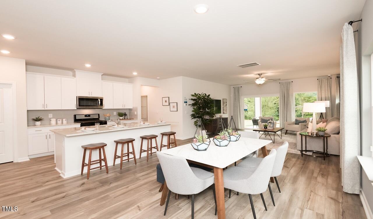 600 Red River Drive Garner, NC 27529 - Photo 5 of 16 a view of a dining room with furniture wooden floor and chandelier