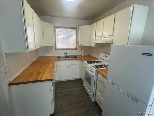 a kitchen with a refrigerator and a stove