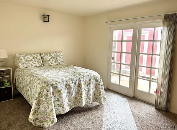 a large bed sitting in a bedroom next to a window
