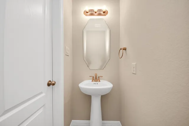 a bathroom with a sink a mirror and a window