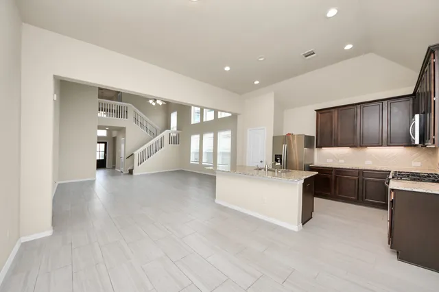 a living room with furniture and kitchen view