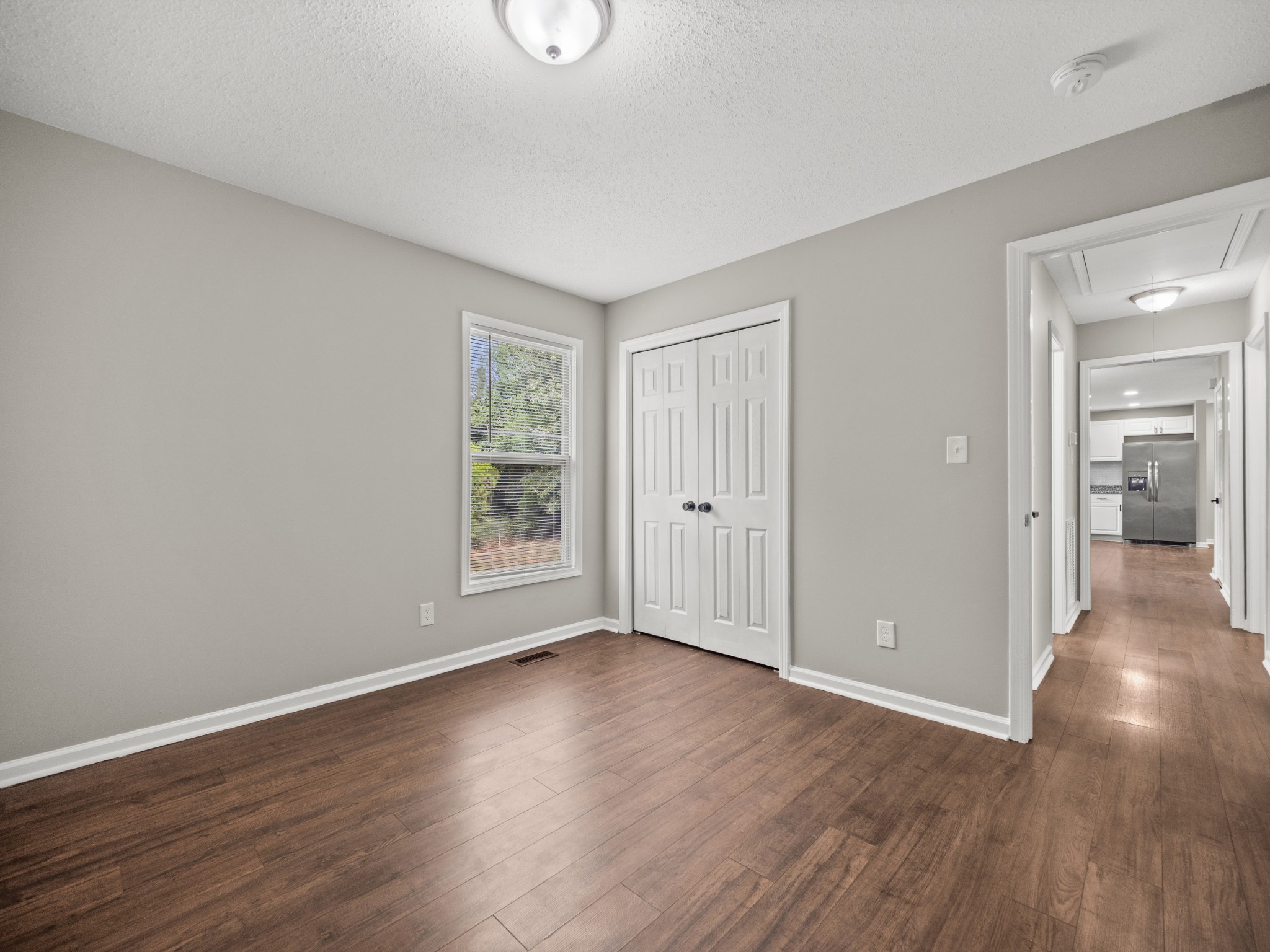 1883 Needmore Road Clarksville, TN 37042 - Photo 12 of 25 an empty room with wooden floor and windows
