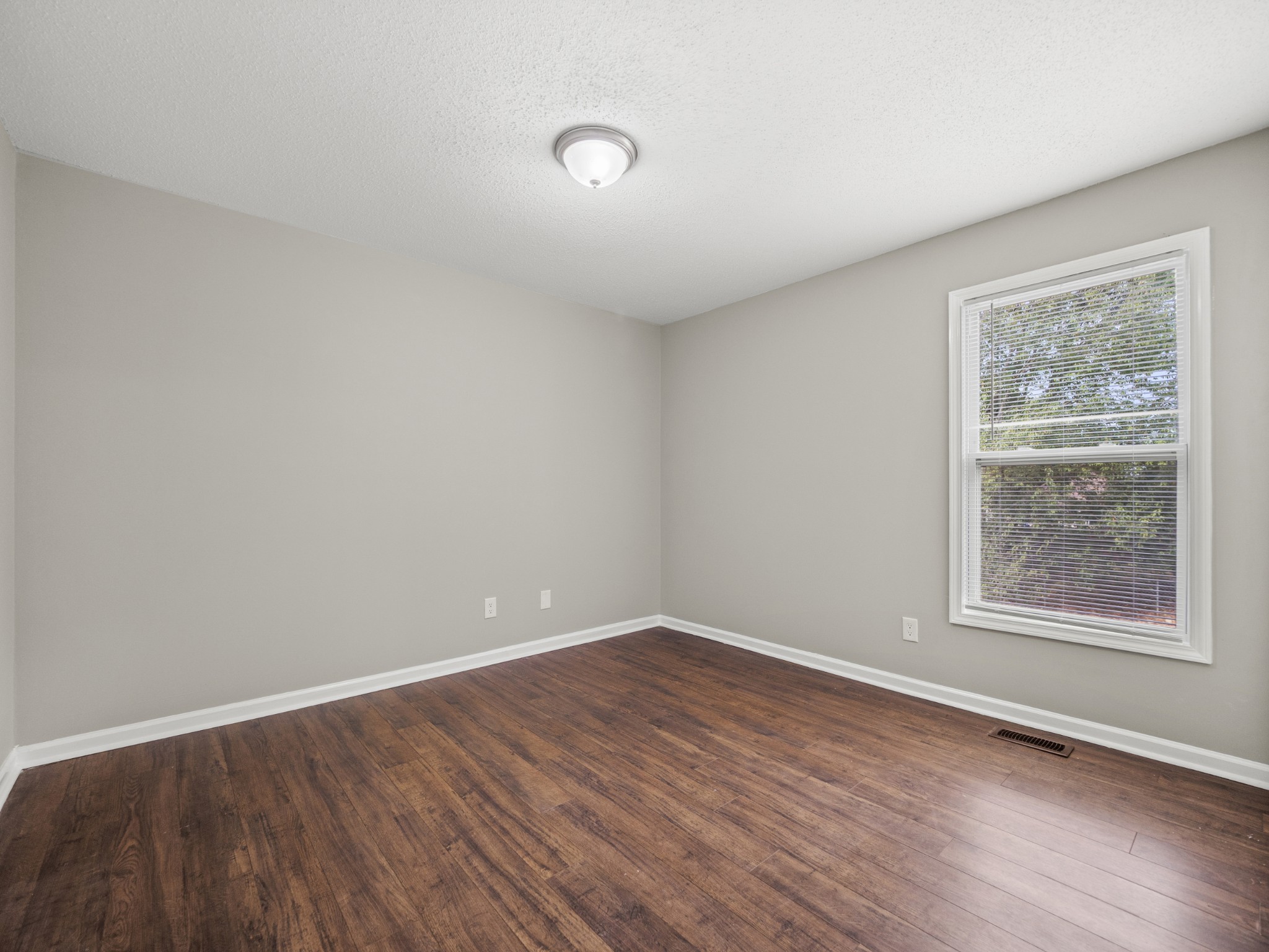 1883 Needmore Road Clarksville, TN 37042 - Photo 16 of 25 an empty room with wooden floor and windows