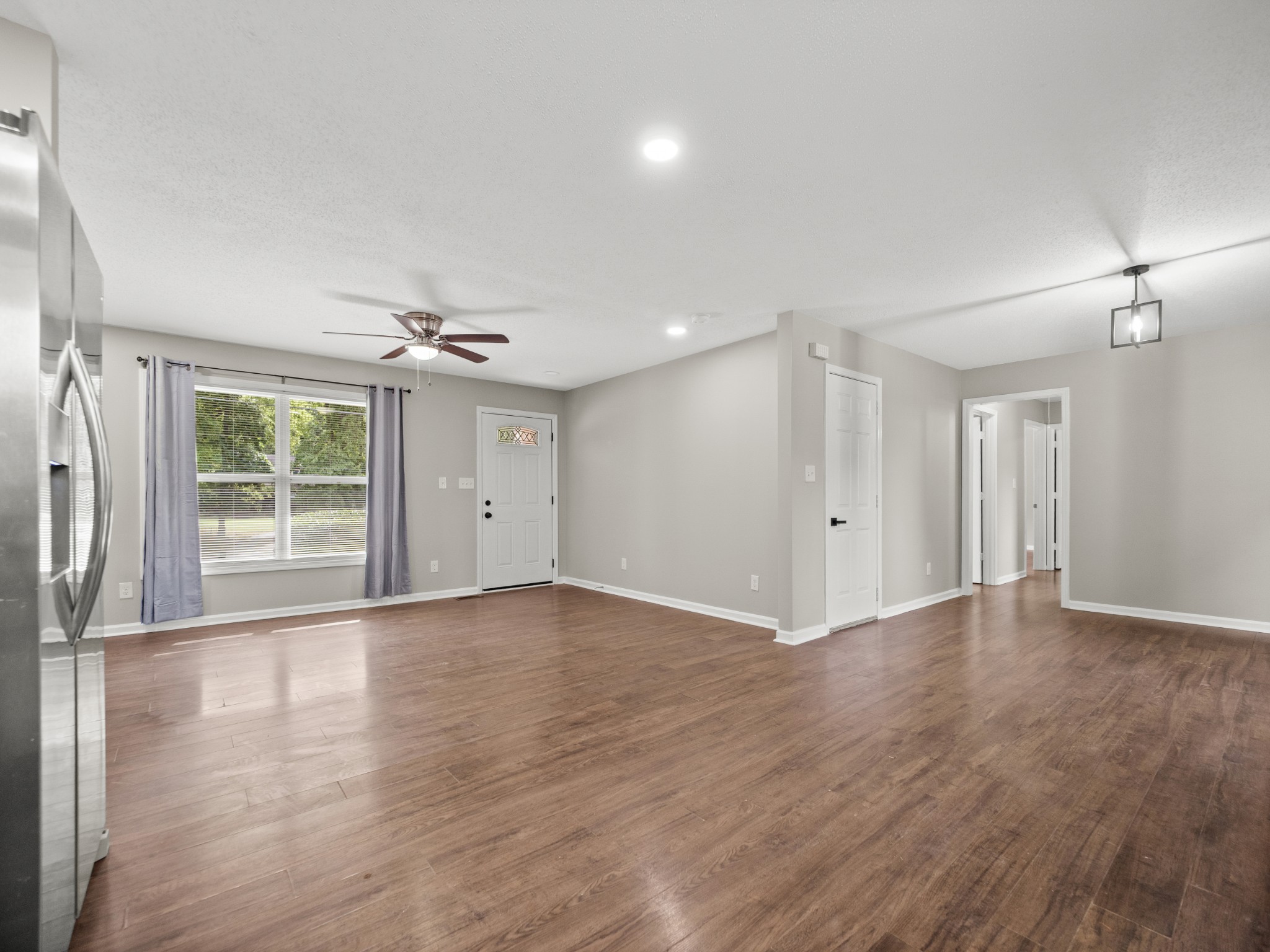 1883 Needmore Road Clarksville, TN 37042 - Photo 18 of 25 a view of an empty room with wooden floor and a window