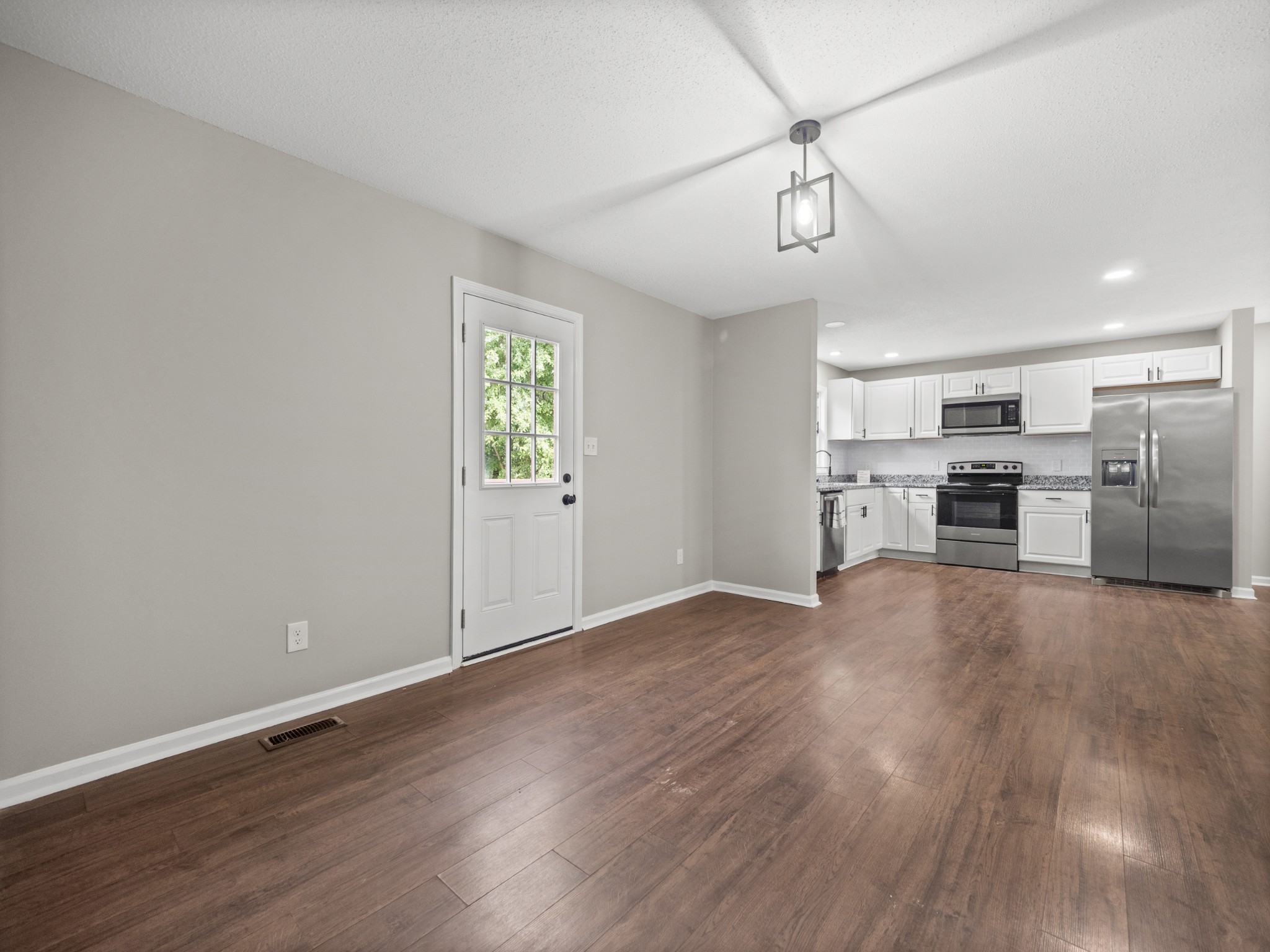 1883 Needmore Road Clarksville, TN 37042 - Photo 19 of 25 a view of a kitchen with a sink stove cabinets and empty room