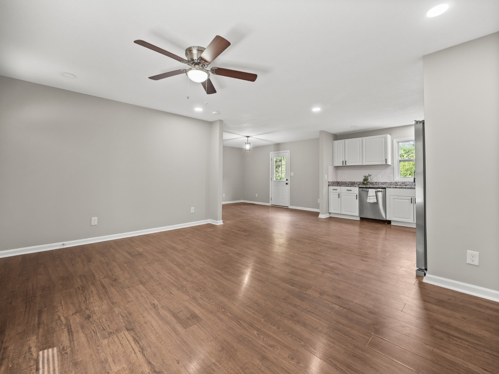 1883 Needmore Road Clarksville, TN 37042 - Photo 20 of 25 a view of a livingroom with a ceiling fan and wooden floor
