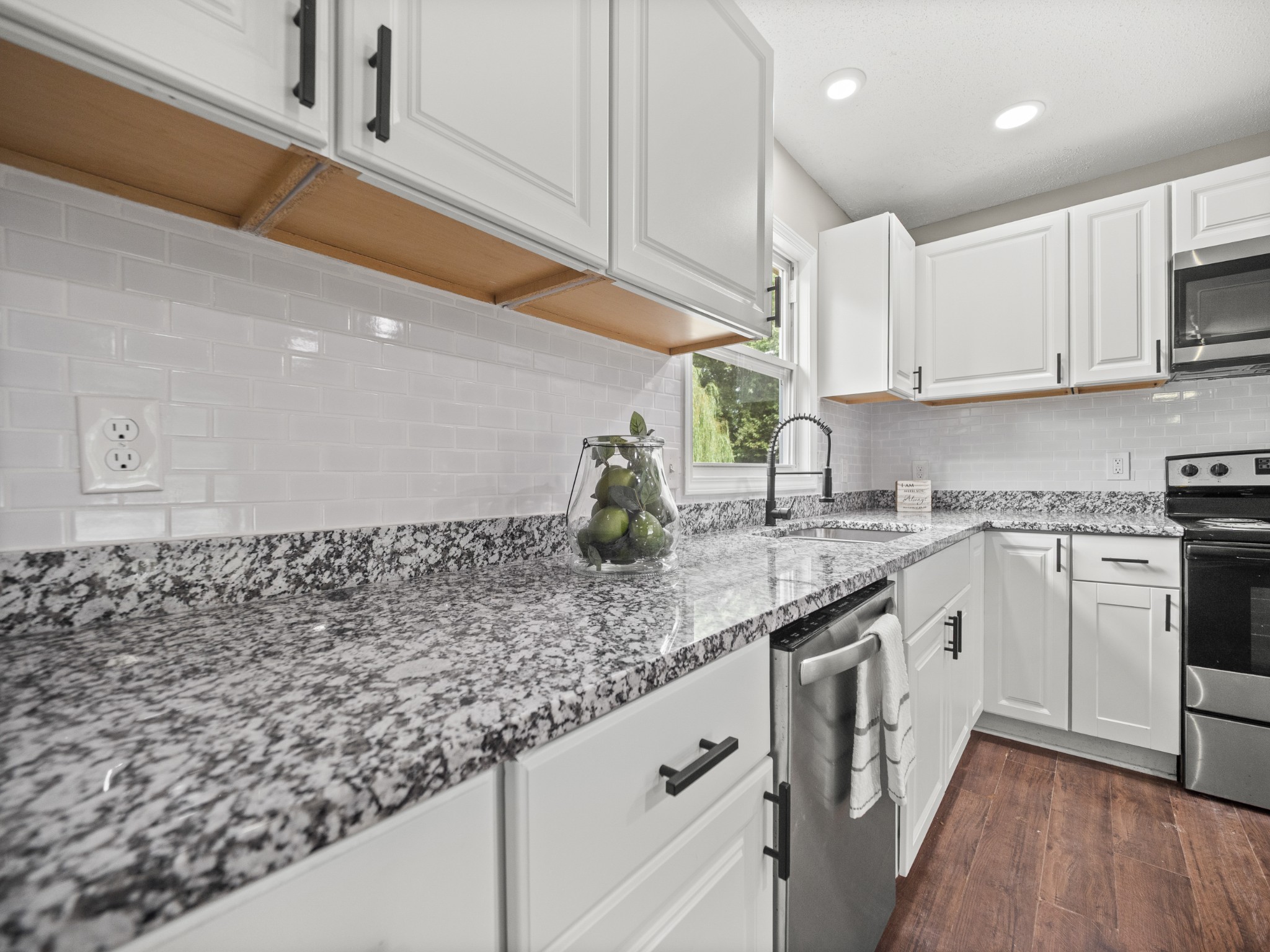 1883 Needmore Road Clarksville, TN 37042 - Photo 5 of 25 a kitchen with stainless steel appliances granite countertop a sink a stove and cabinets