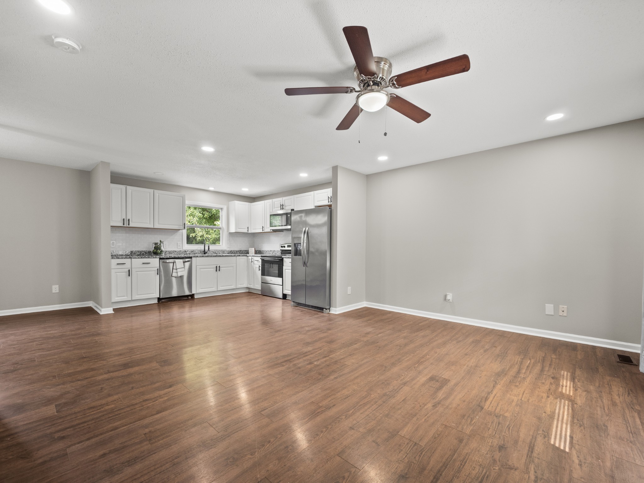 1883 Needmore Road Clarksville, TN 37042 - Photo 6 of 25 a view of a livingroom with a ceiling fan & hardwood floor