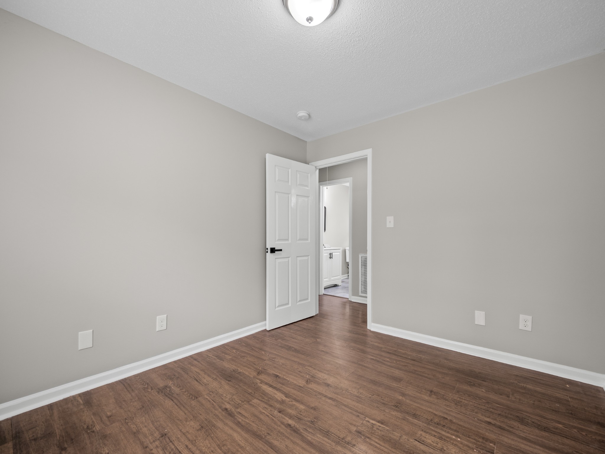 1883 Needmore Road Clarksville, TN 37042 - Photo 9 of 25 a view of an empty room with wooden floor