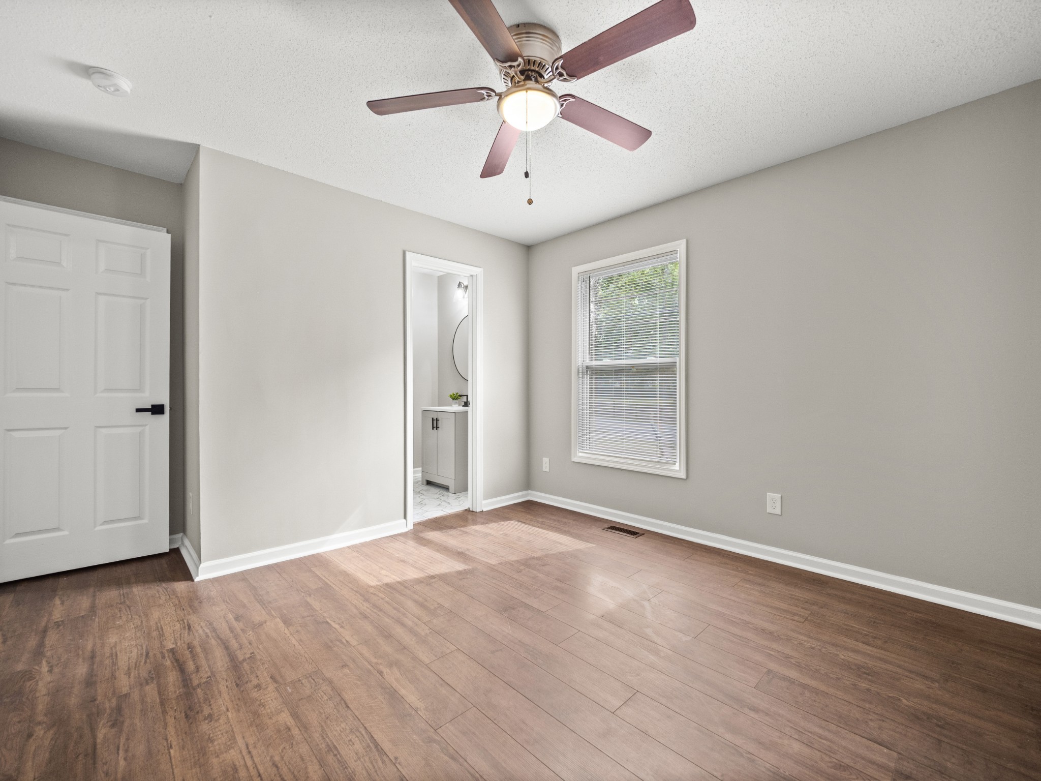 1883 Needmore Road Clarksville, TN 37042 - Photo 10 of 25 wooden floor in an empty room with a window