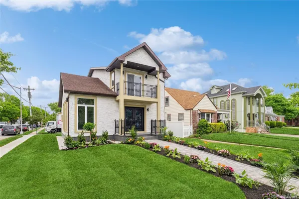 a front view of a house with a yard