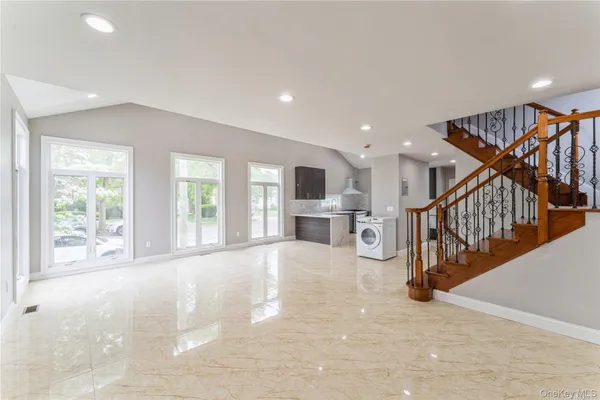 a view of an entryway with wooden floor and a floor to ceiling window
