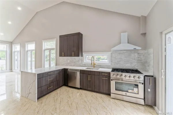 a kitchen with stainless steel appliances granite countertop a stove and a sink
