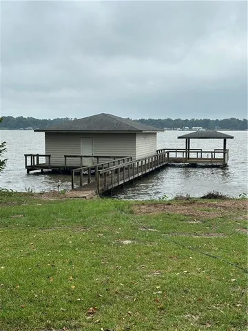 a view of a swimming pool with an outdoor seating and a yard