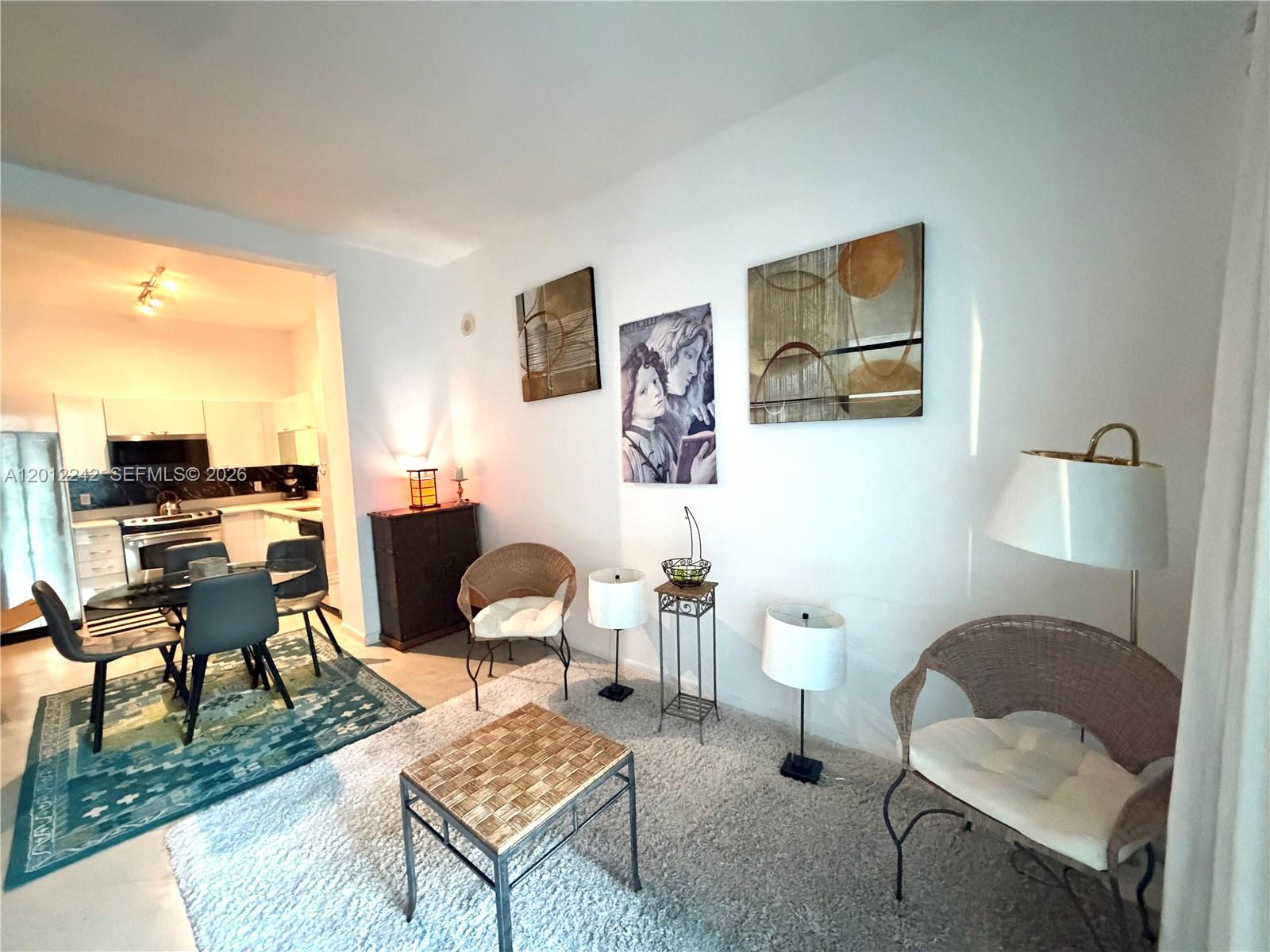 234 Northeast 3rd Street, Unit 1908 Miami, FL 33132 - Photo 14 of 16 a living room with furniture and a window
