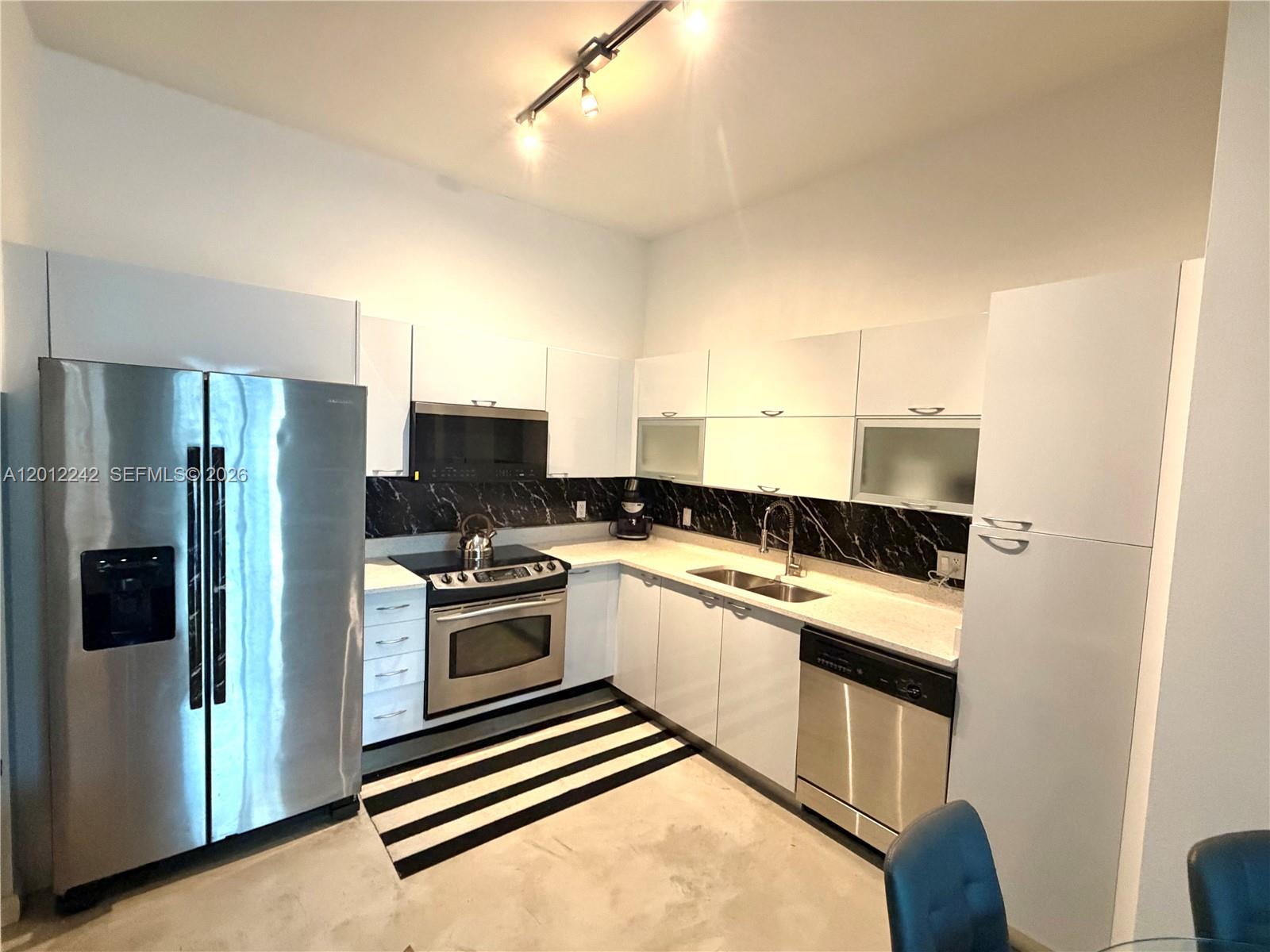 234 Northeast 3rd Street, Unit 1908 Miami, FL 33132 - Photo 5 of 16 a kitchen with a sink stove and refrigerator