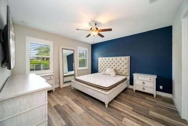 a spacious bedroom with a bed and a large window