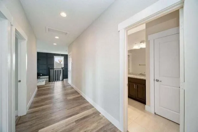 a view of hallway with wooden floor