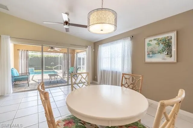 a view of a dining room with furniture wooden floor and a chandelier