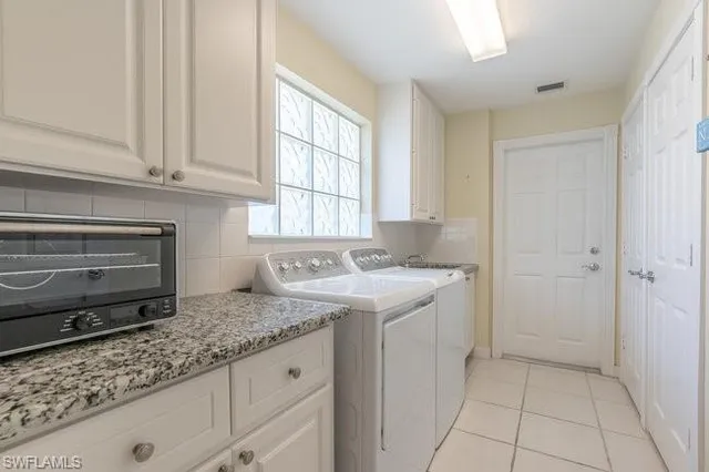 a kitchen with granite countertop a sink and a stove