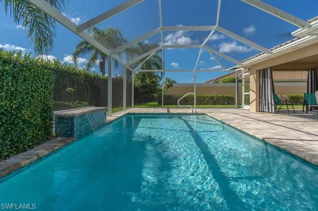 a view of backyard with swimming pool and seating area