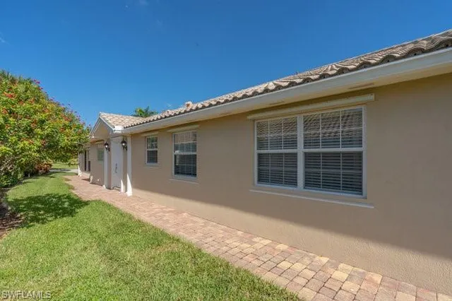 a front view of a house with a garden and yard