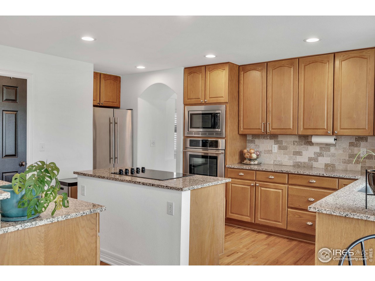 3058 West 111th Drive Westminster, CO 80031 - Photo 11 of 39 a kitchen with stainless steel appliances granite countertop a refrigerator and a sink