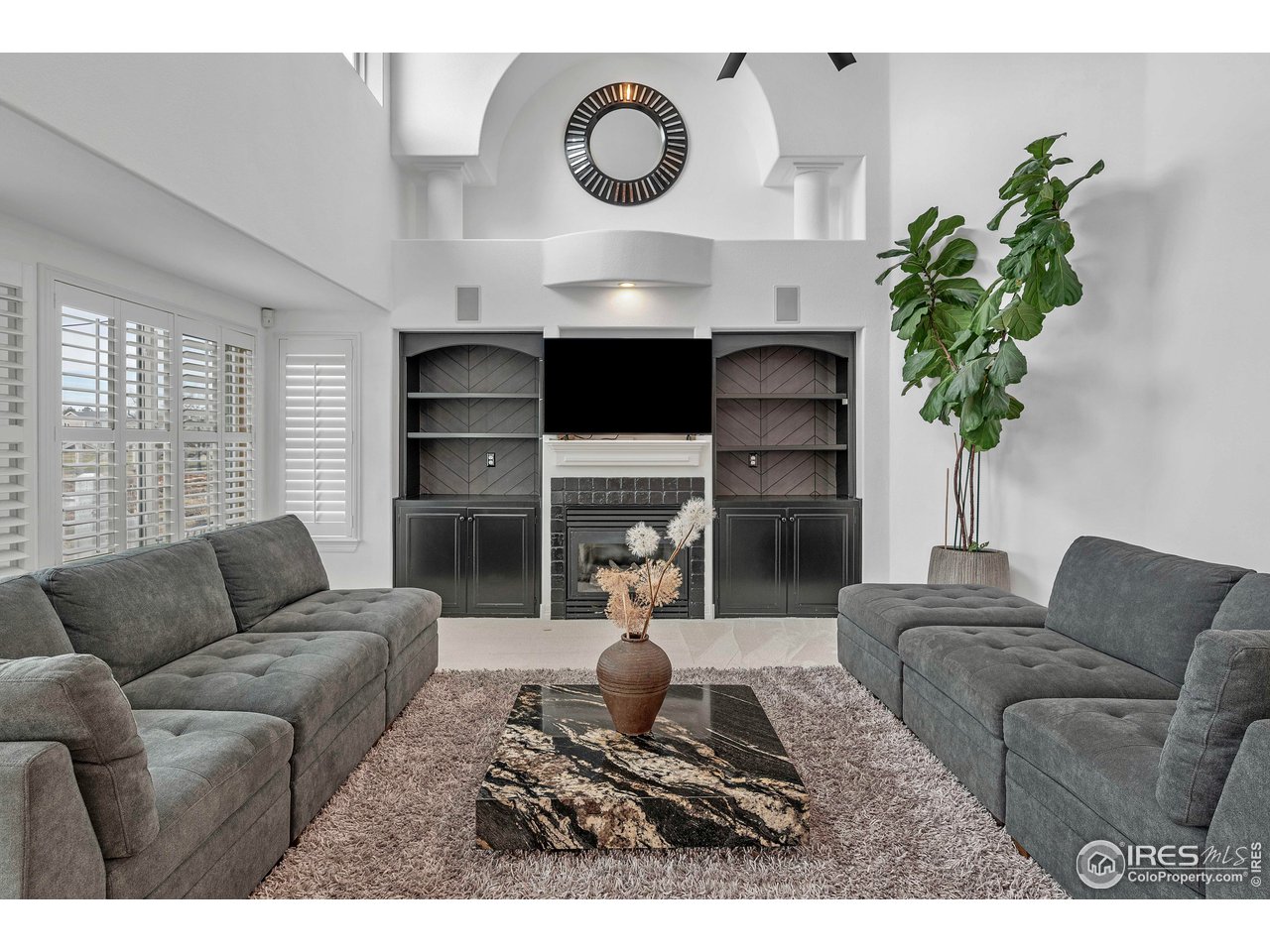 3058 West 111th Drive Westminster, CO 80031 - Photo 14 of 39 a living room with furniture a fireplace and a potted plant