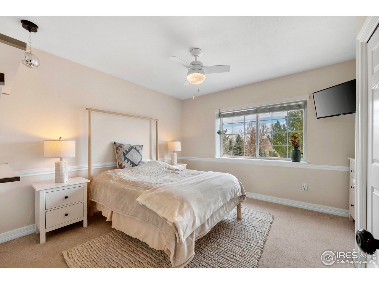 3058 West 111th Drive Westminster, CO 80031 - Photo 20 of 39 a bedroom with a large bed and a window