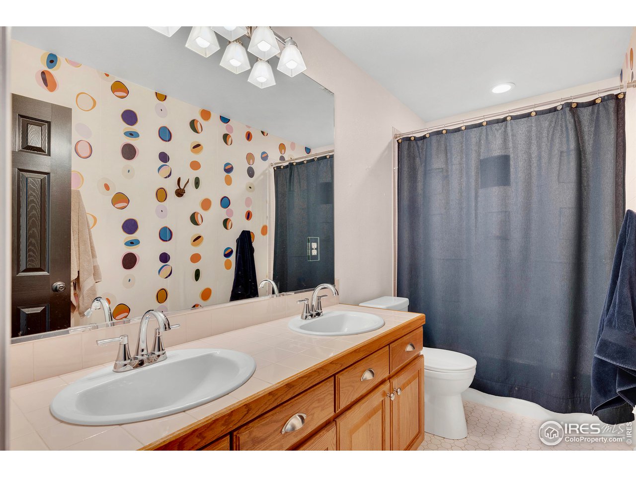 3058 West 111th Drive Westminster, CO 80031 - Photo 22 of 39 a bathroom with a sink and a mirror
